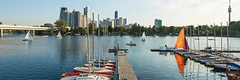 Summer day on the Old Danube, boats in the water, Vienna skyline in the background