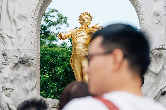 Vienna City Park, Johann Strauss monument, tourists in the foreground