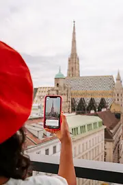 Woman with smartphone, and St. Stephen's Cathedral in the background