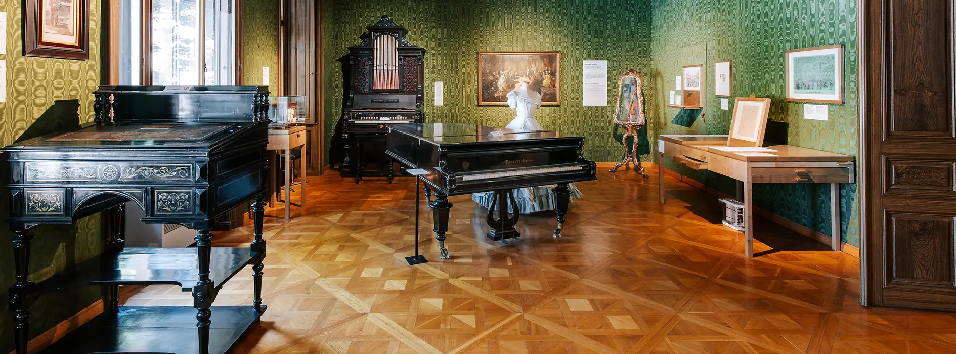 Green salon in the Strauss apartment with music stand, piano and violin case