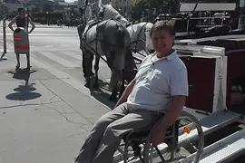 Man in a wheelchair in carriage with a ramp